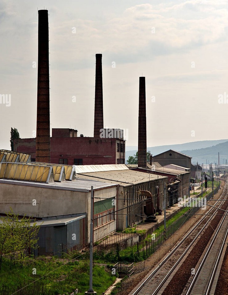 old-factory-with-chimneys-and-railroad-with-pink-sky-bb1a7r